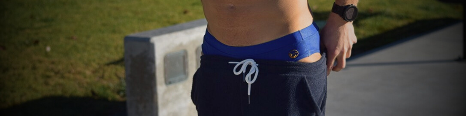 swimmer putting a terry cloth shorts